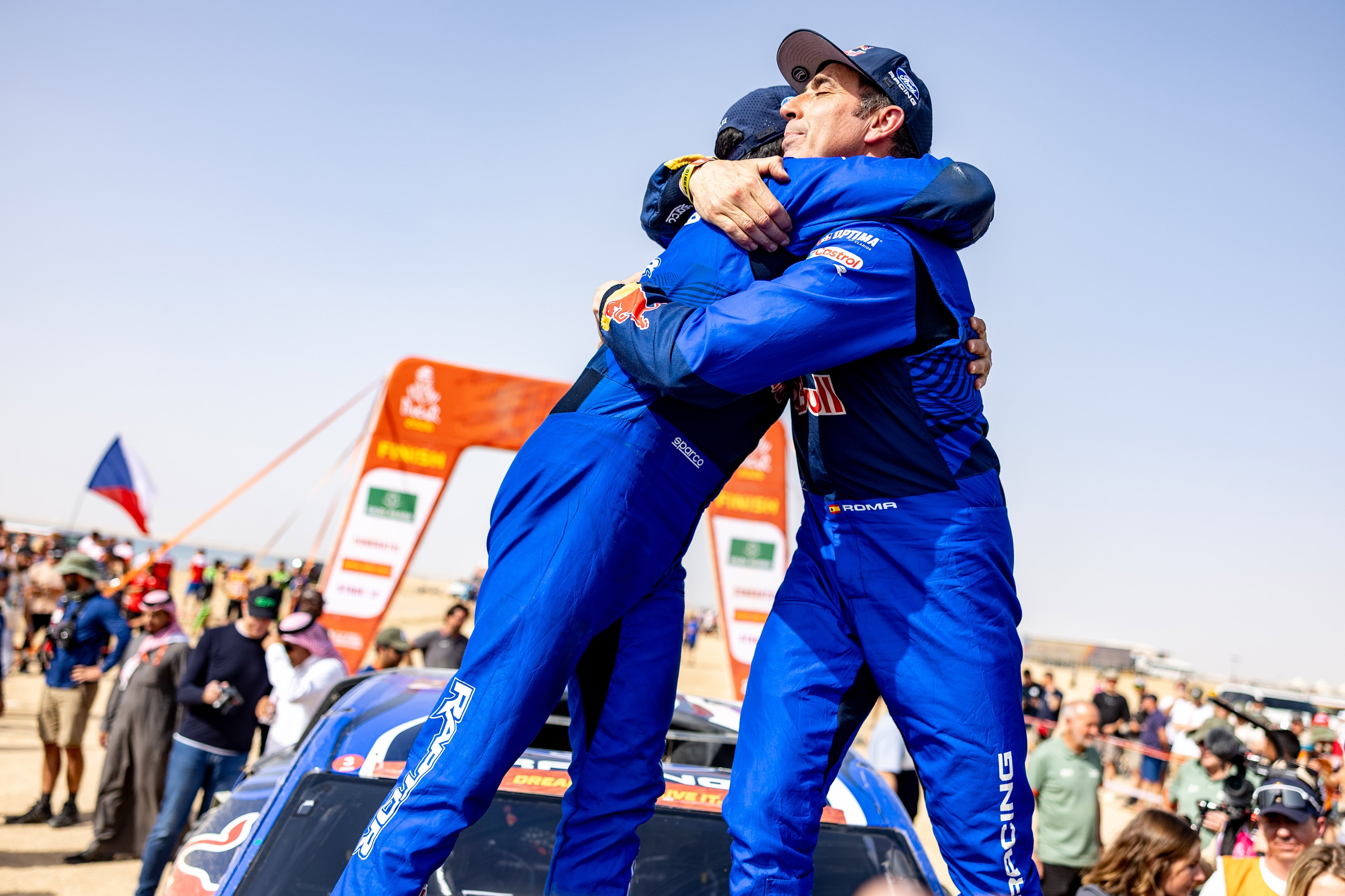 Alex Haro and Nani Roma embrace after 2026 Dakar Rally finish.