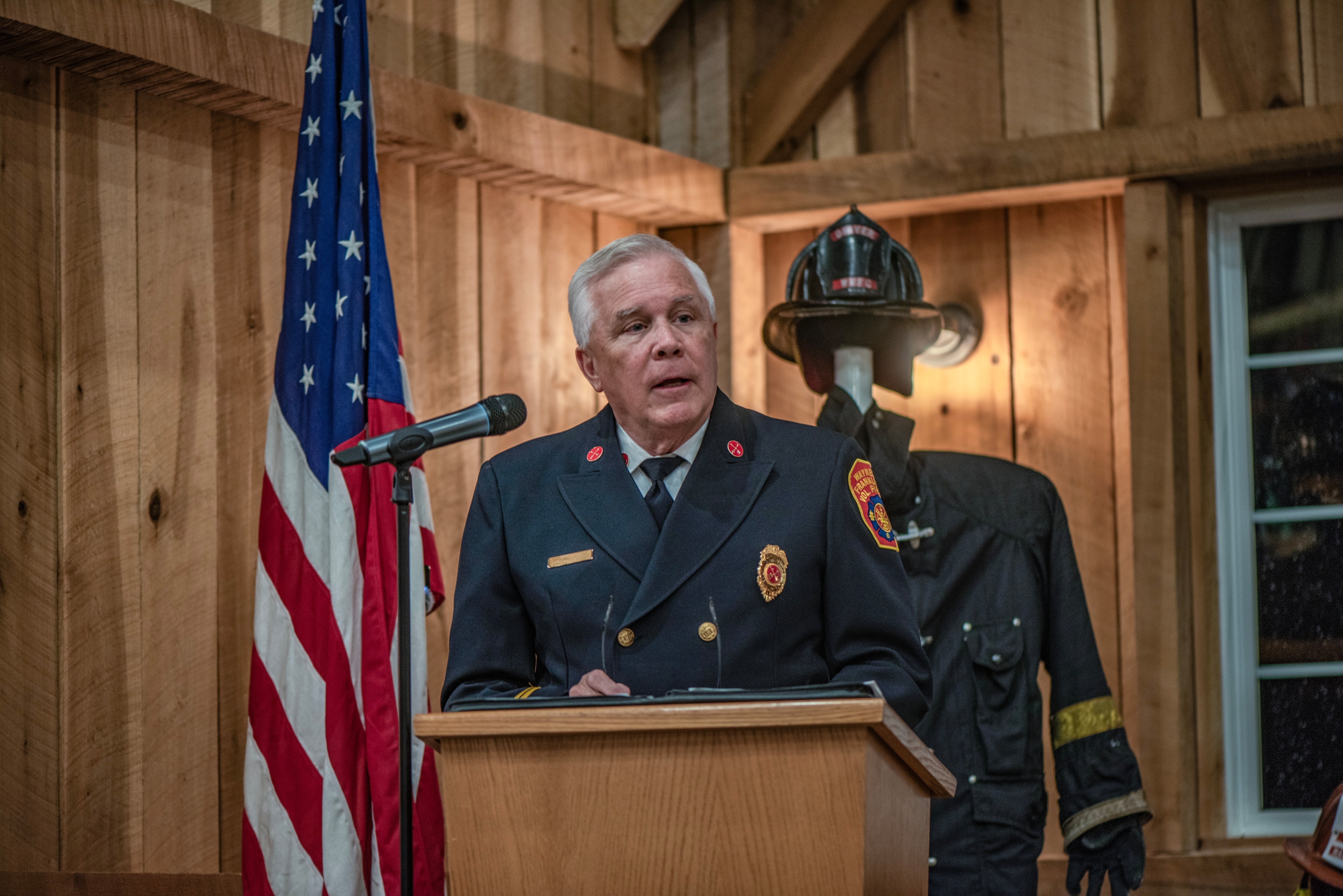 Mark Fox, Fox Ford dealer principal and volunteer firefighter, addresses the community gathered to celebrate the Waynesburg Volunteer Fire Department’s 100th anniversary.