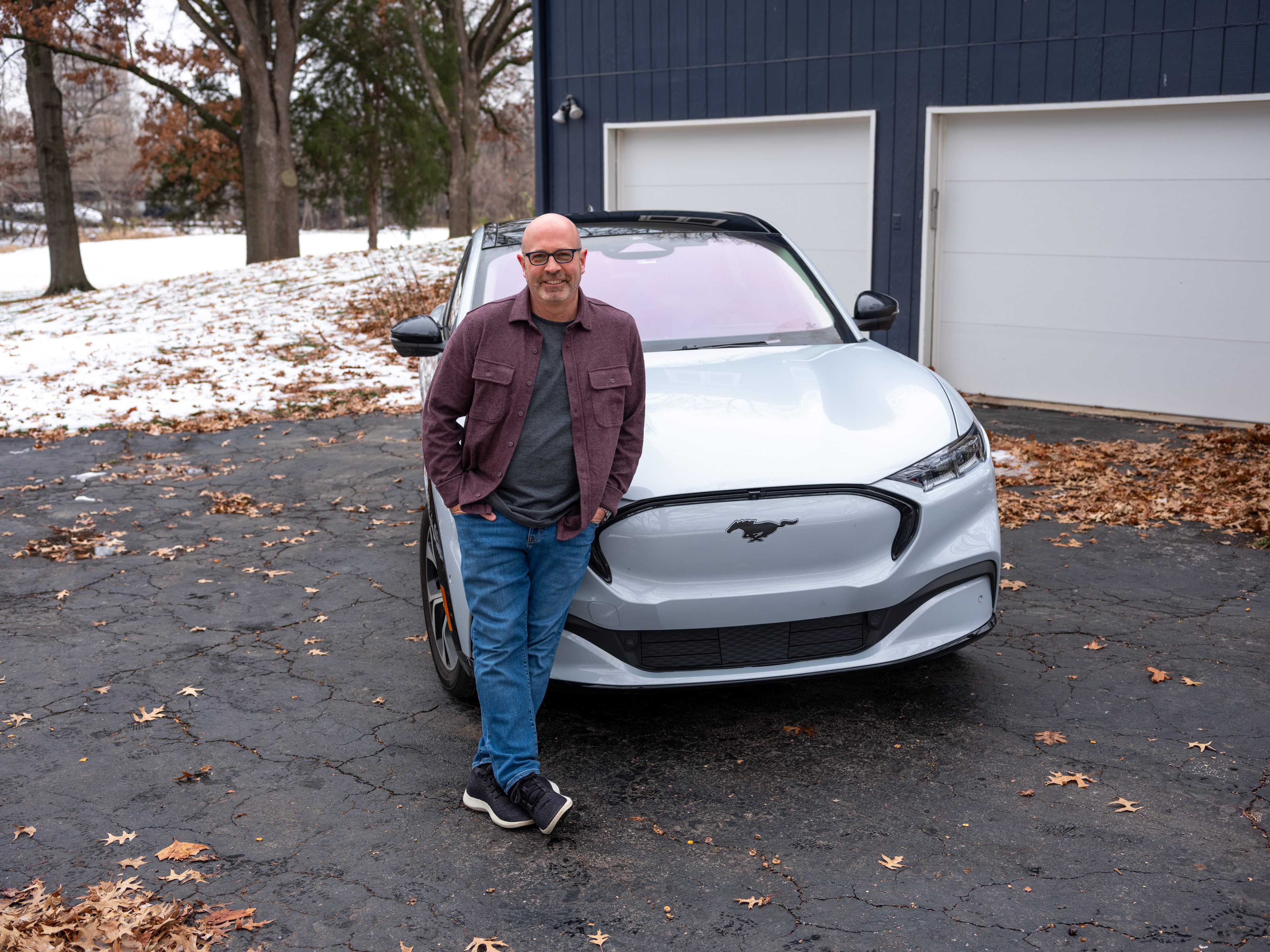 Todd posing with the Mustang Mach-E.