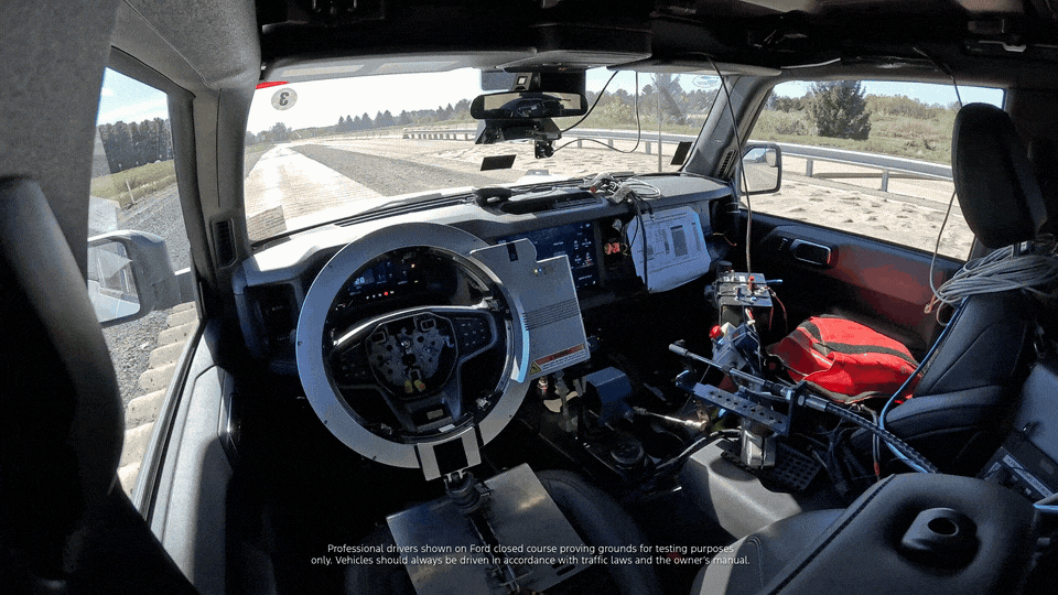 A GIF shows a vehicle first from the inside and then from the outside as it drives autonomously over a concrete-surfaced tracks with bumps and broken concrete pieces for testing.