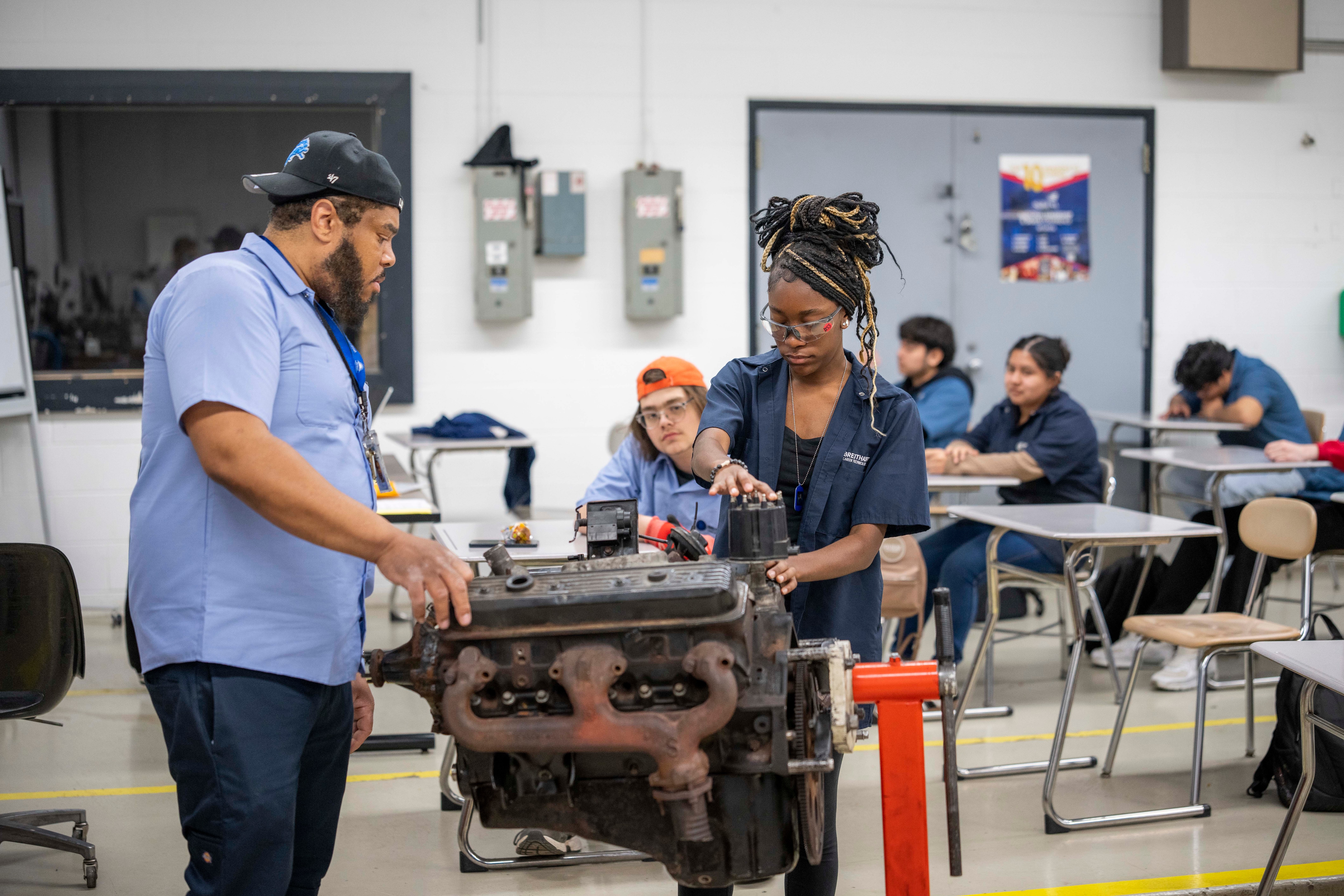 Dallis inspects under the hood of a car with her teacher at the Breithaupt Career Technical Center. After graduation, she plans to go into the trades as a career and has signed a pledge to do so, on May 6, 2026, in Detroit, Michigan.Photos by Adam Schultzadam.schultz@gmail.com