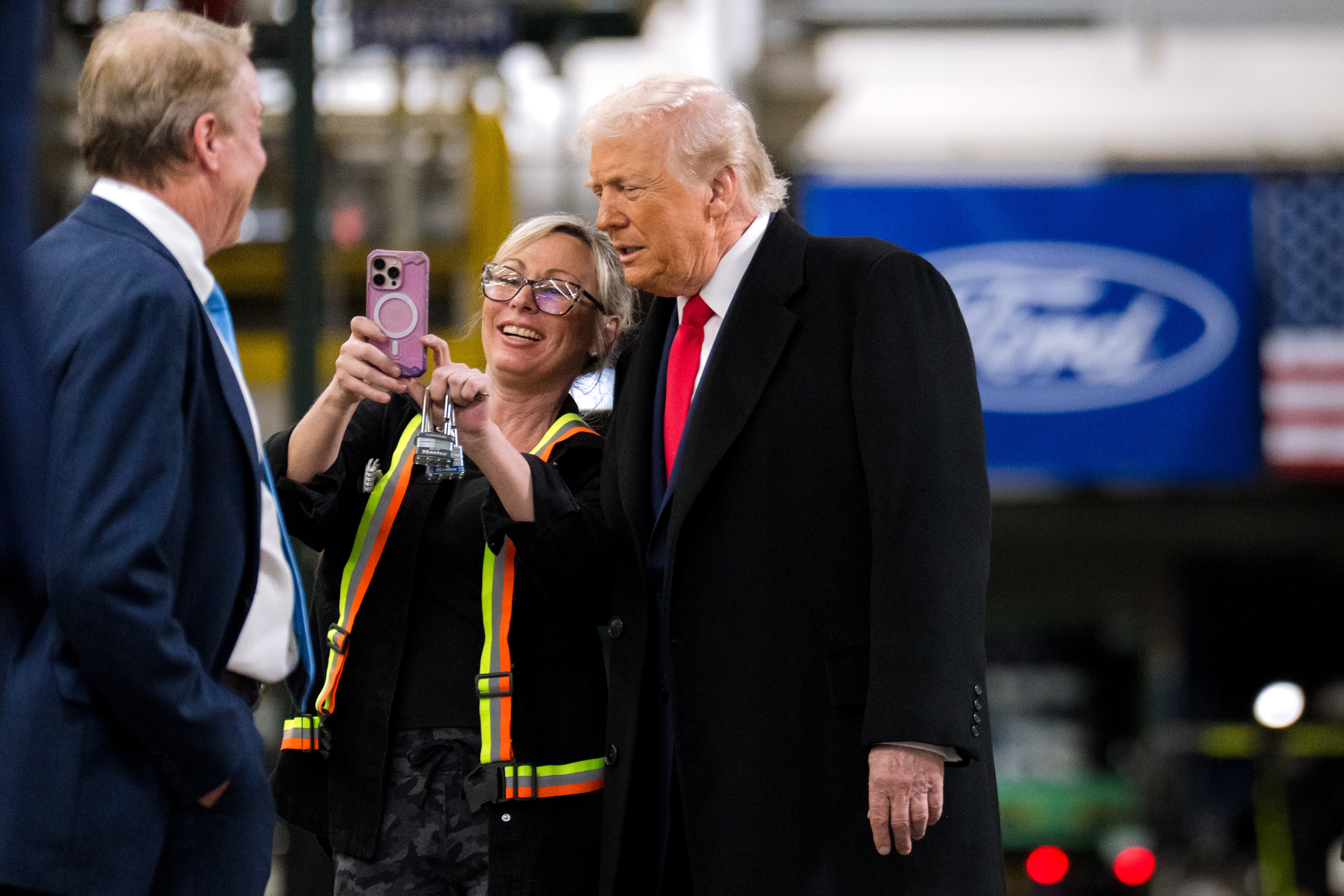 Kristina "Krissy" Awishes, Dearborn Truck Plant employee, takes a photo with President Donald Trump during a tour of the assembly operations at Dearborn Truck Plant, home of F-150 (gas and hybrid) and F-150 Raptor. At the request of the White House, Ford hosted President Donald Trump and Treasury Secretary Scott Bessent at the Ford Rouge Center on Tuesday, Jan. 13, 2026.