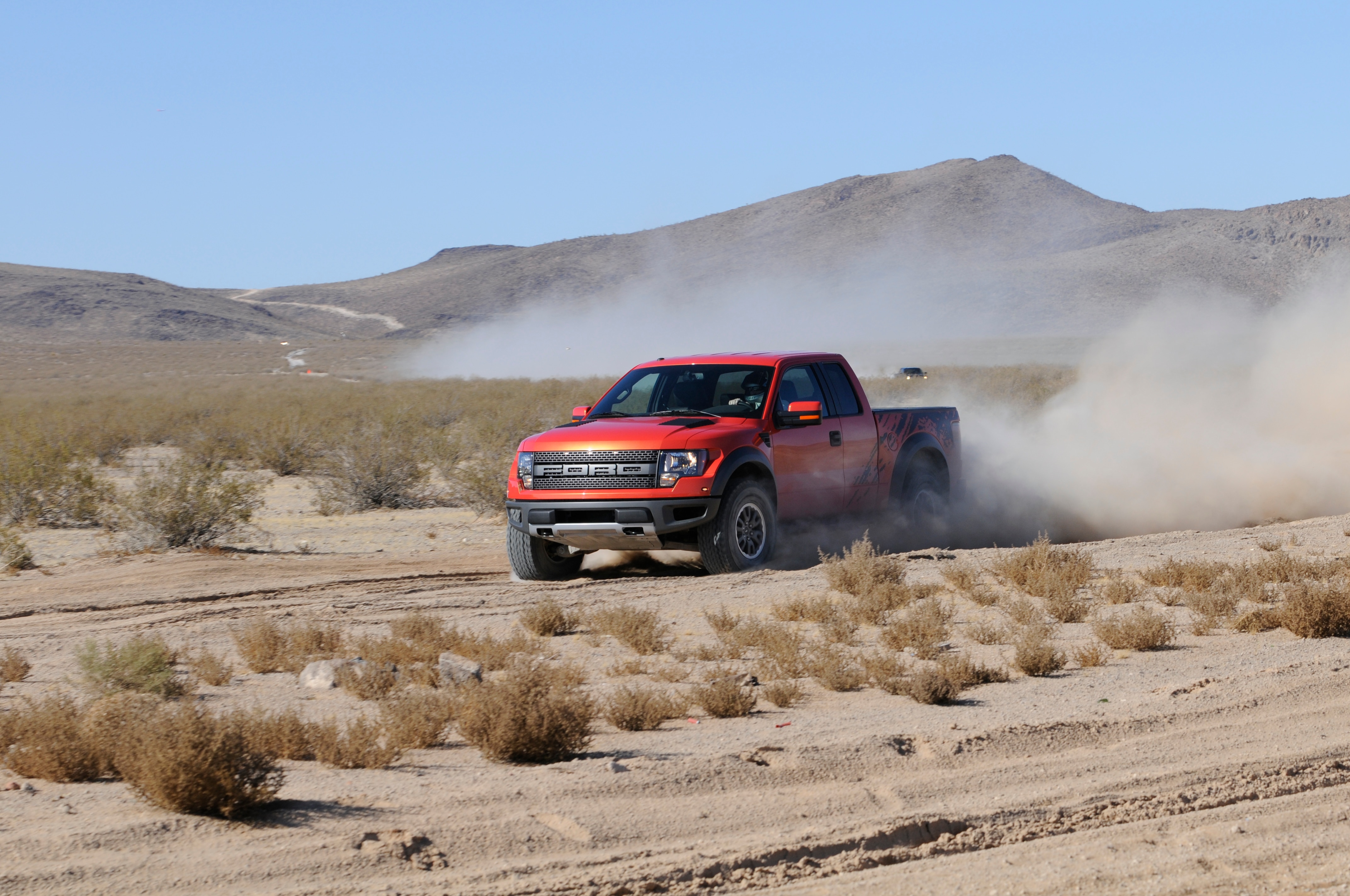 An original 2008 Ford Raptor prototype powers through the open desert landscape.