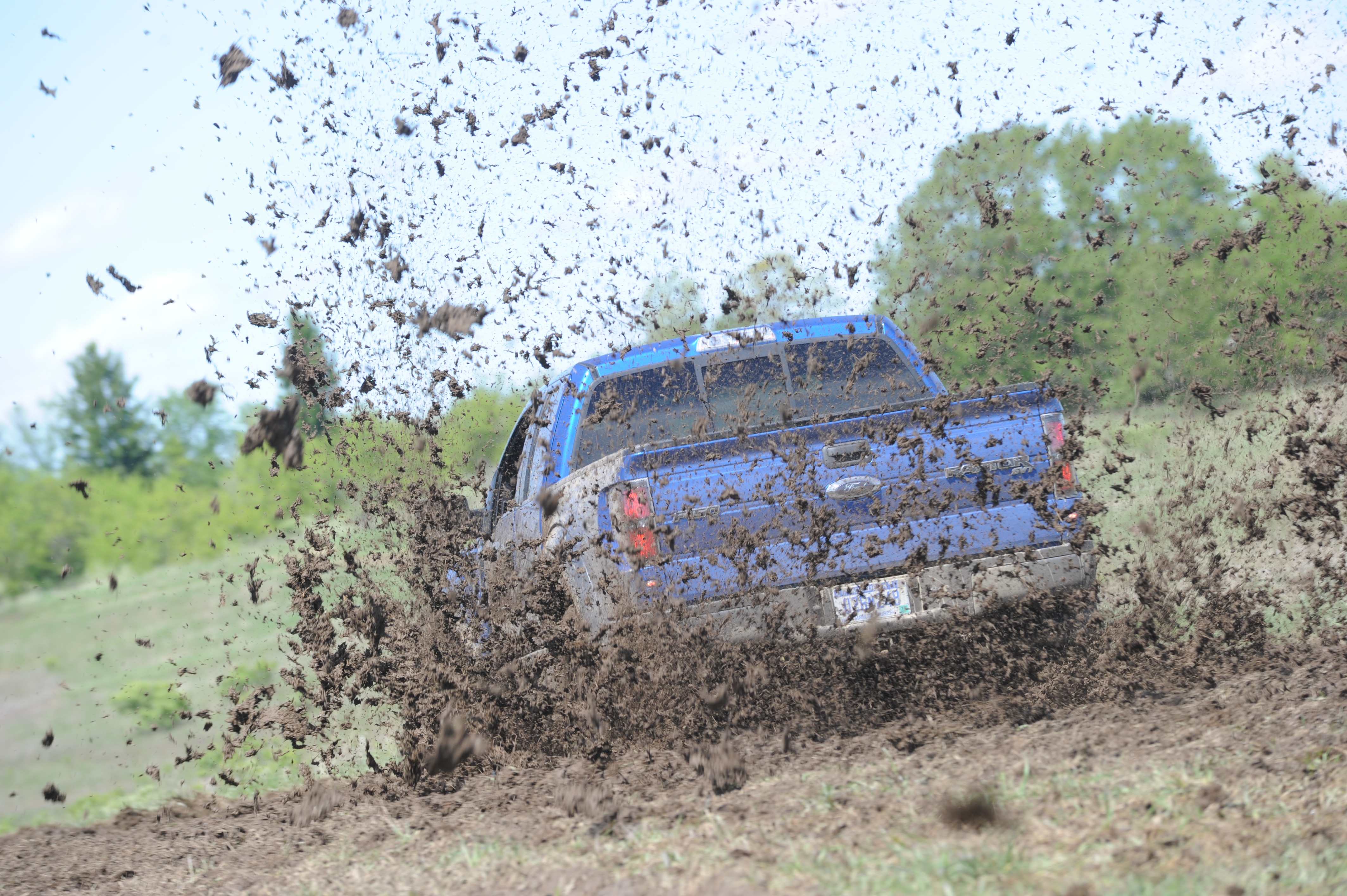 An action shot captures the original 2008 Raptor undergoing dynamic off-road testing.