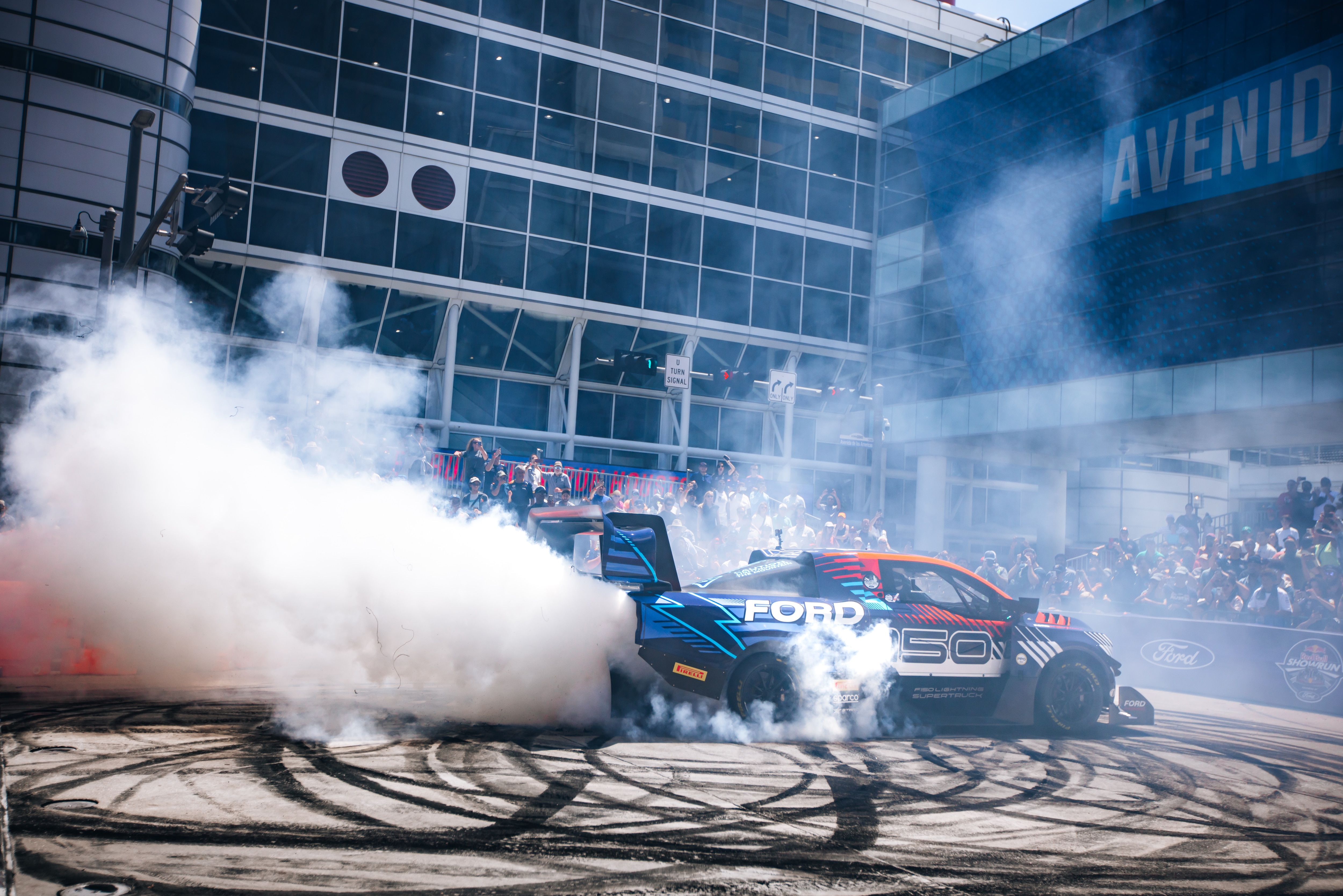 A Ford Red Bull SuperTruck circles a track in Houston.