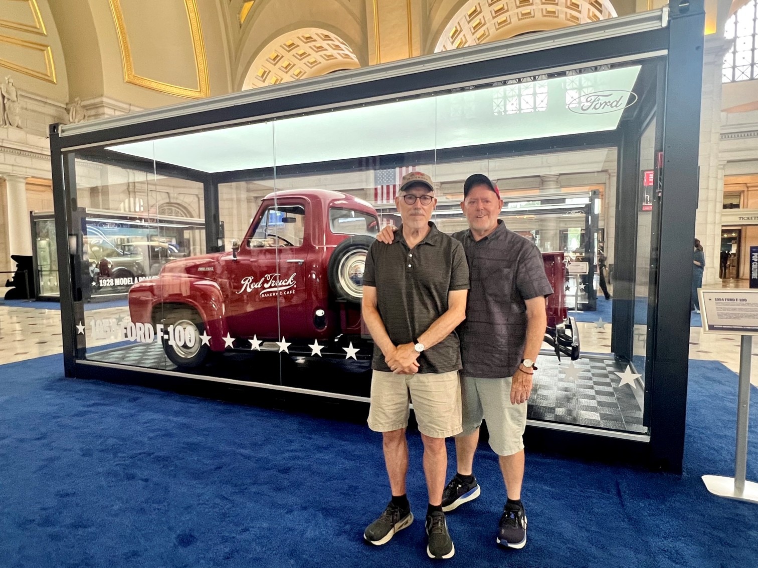Red Truck Bakery founder, Brian Noyes (right) and spouse, Dwight McNeill, with the 1954 Ford F-100 at the Driving America Forward event at Union Station.