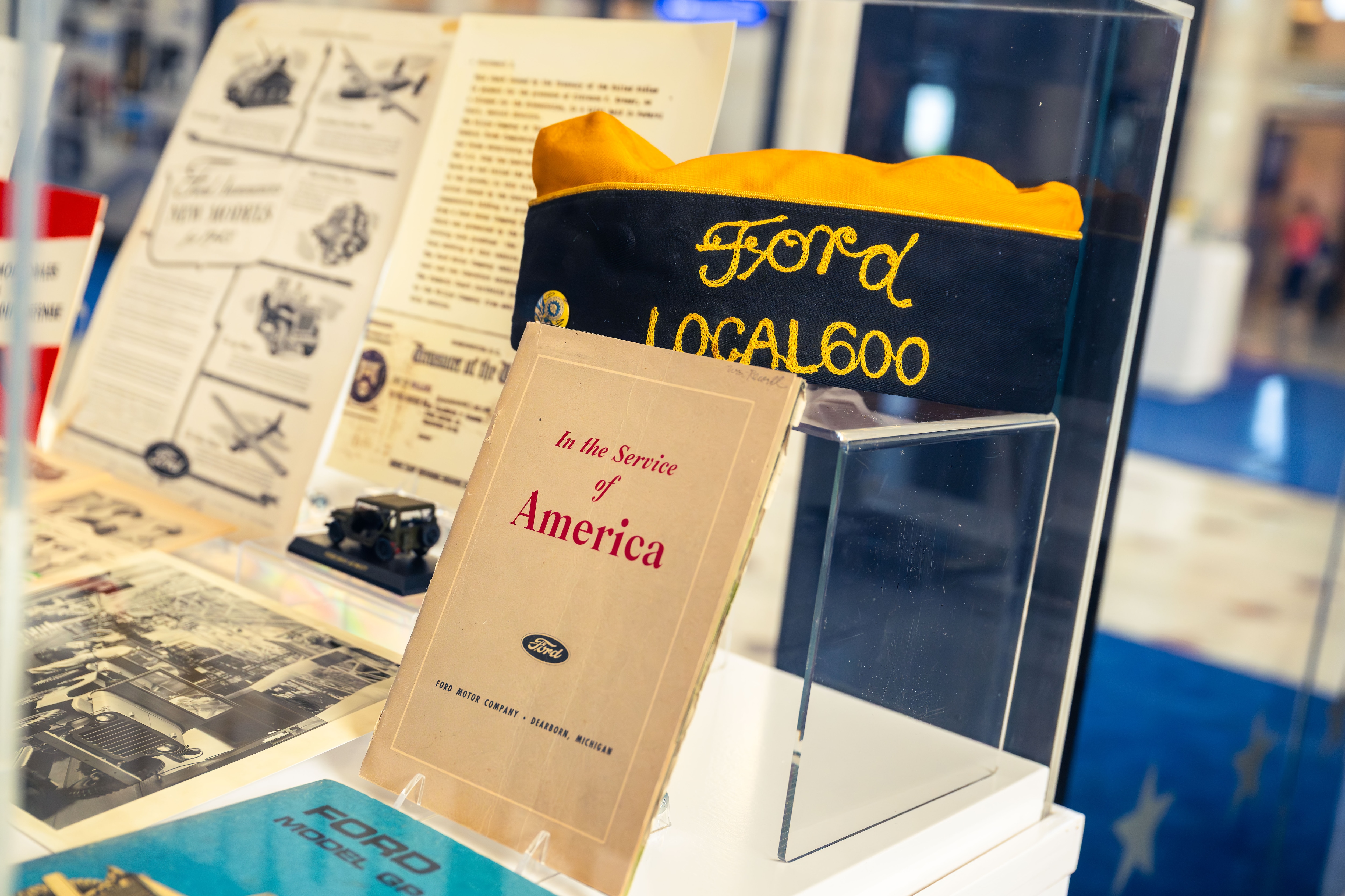 Directly alongside the 1941 Ford GP is a curated historical display case containing rare treasures from the Ford archives.