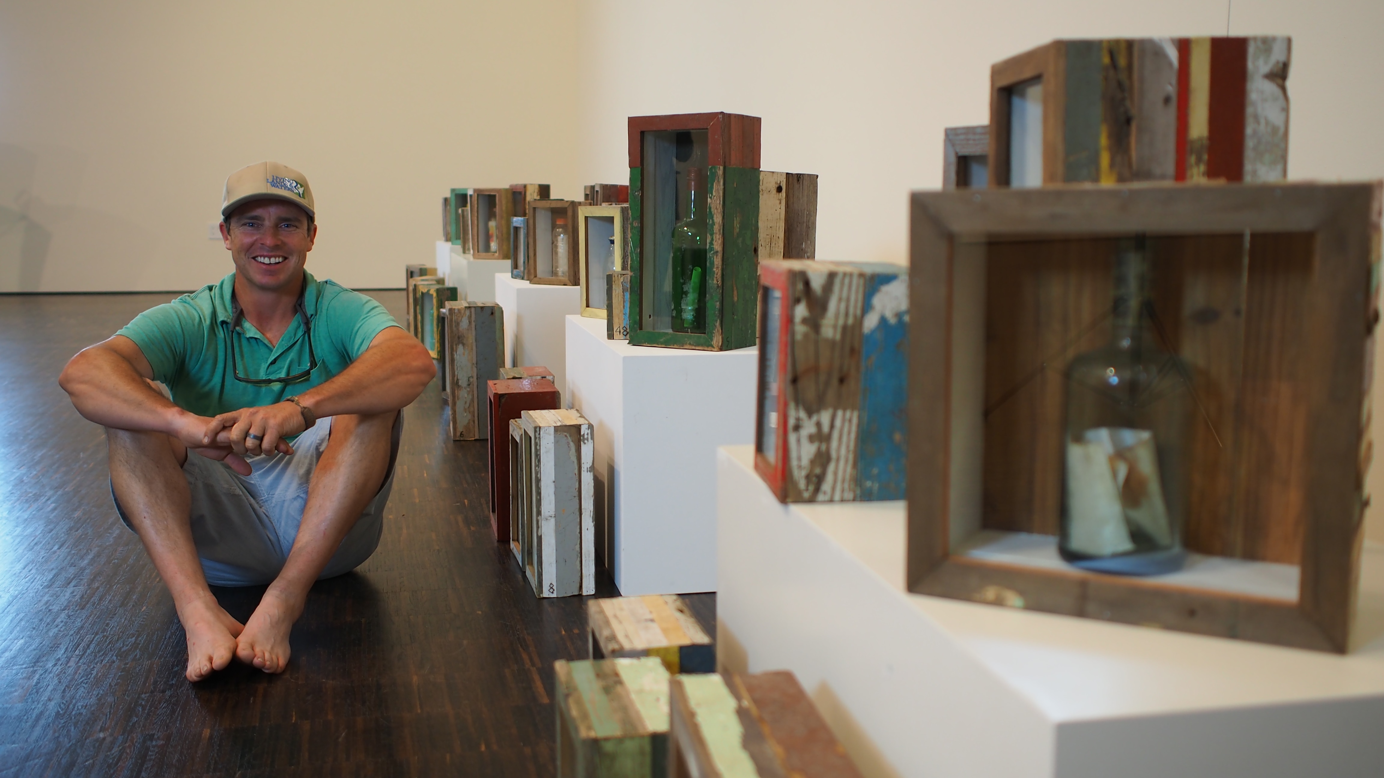Living Lands & Waters founder Chad Pregracke shows off message in a bottle collection.