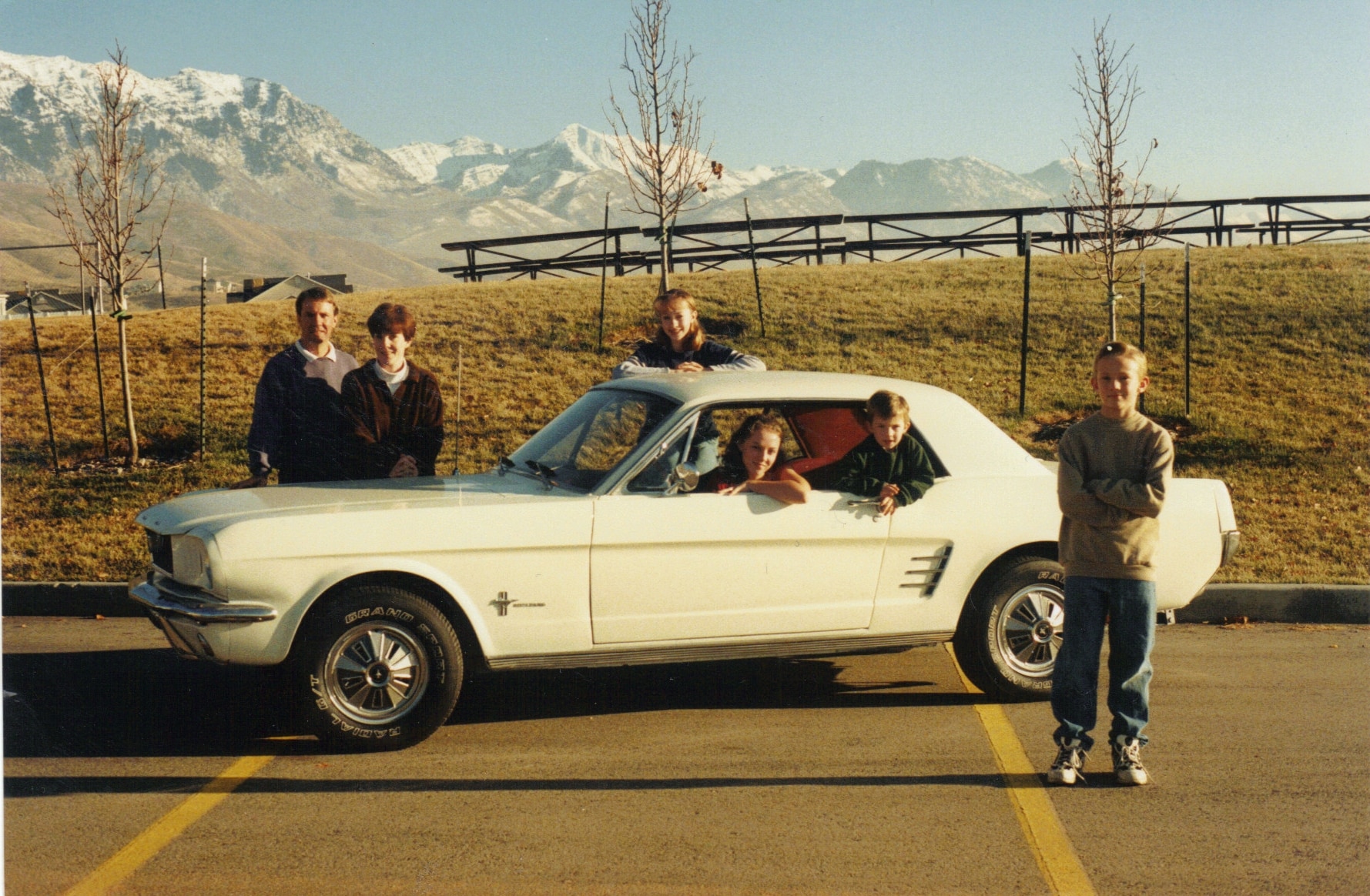 The family Mustang is at the center of each family photo from 1998 to 2025.