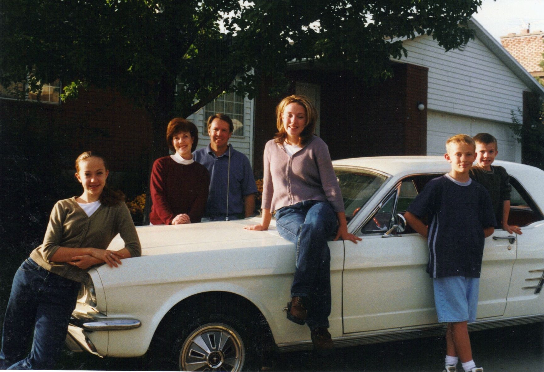 The family Mustang is at the center of each family photo from 1998 to 2025.