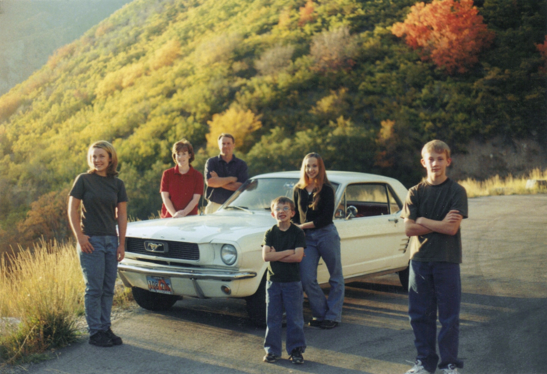 The family Mustang is at the center of each family photo from 1998 to 2025.