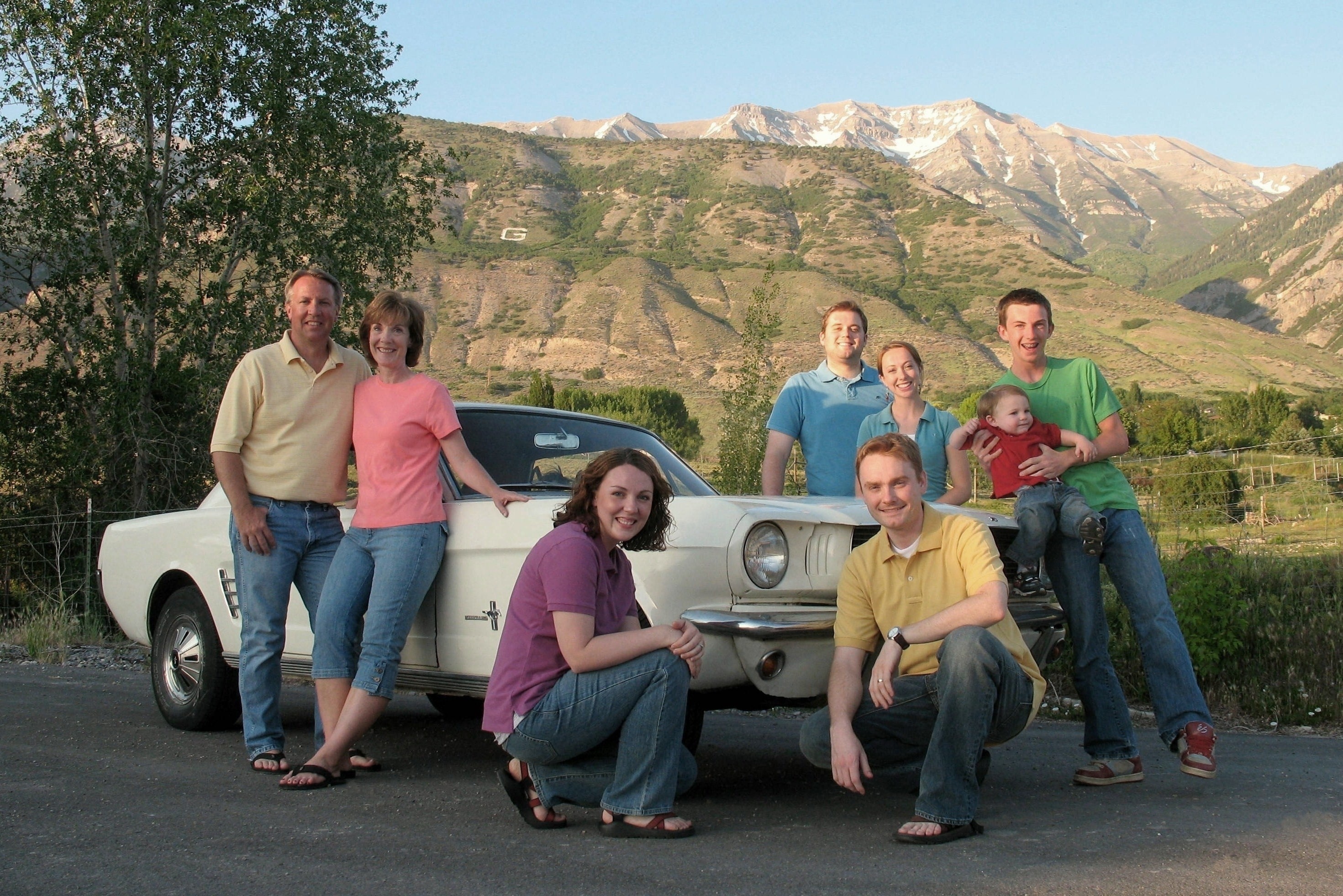 The family Mustang is at the center of each family photo from 1998 to 2025.