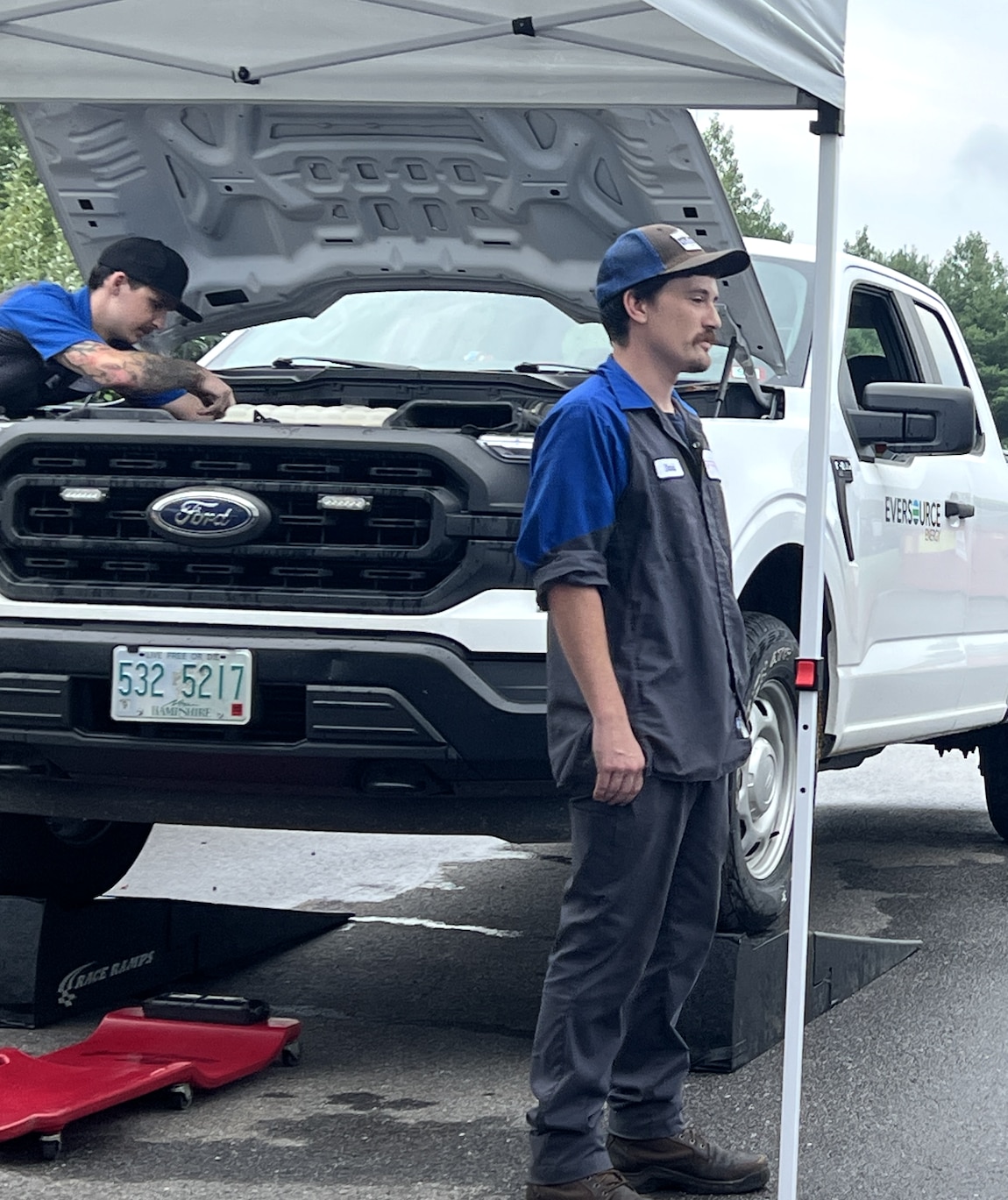 Ford Mobile Service technician Dave Bosquet talks with Governor Ayotte during a food drive on July 31 where Grappone Ford offered complimentary oil changes in exchange for donated goods. Bosquet attended the Boys and Girls Club when he was younger. 