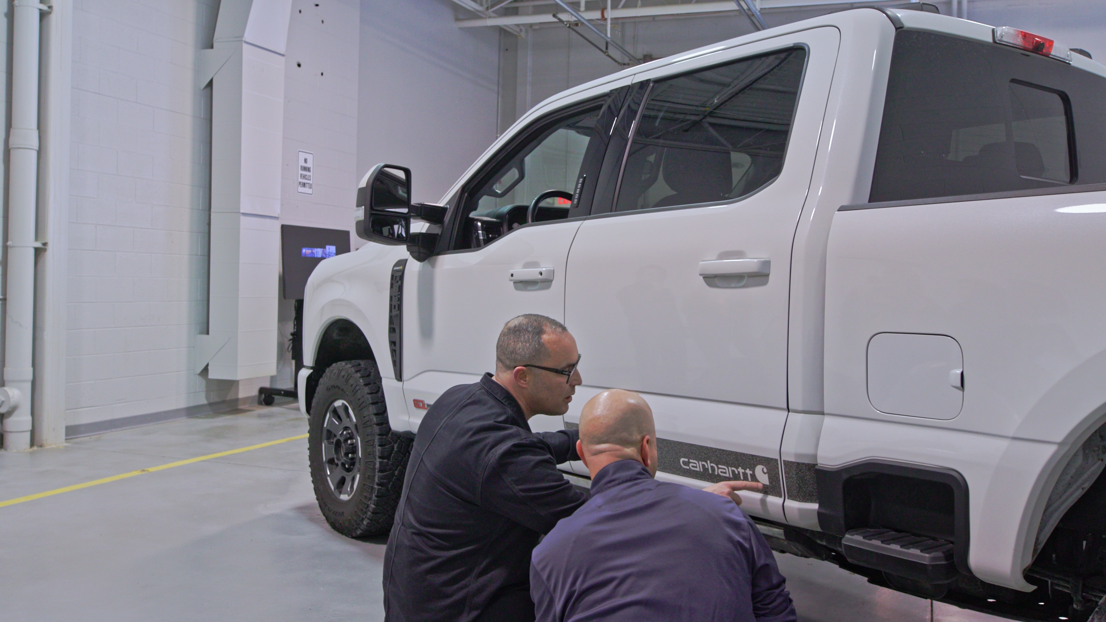 Steve Gilmore and Ben Ewy examine the Carhartt logo on the Super Duty.