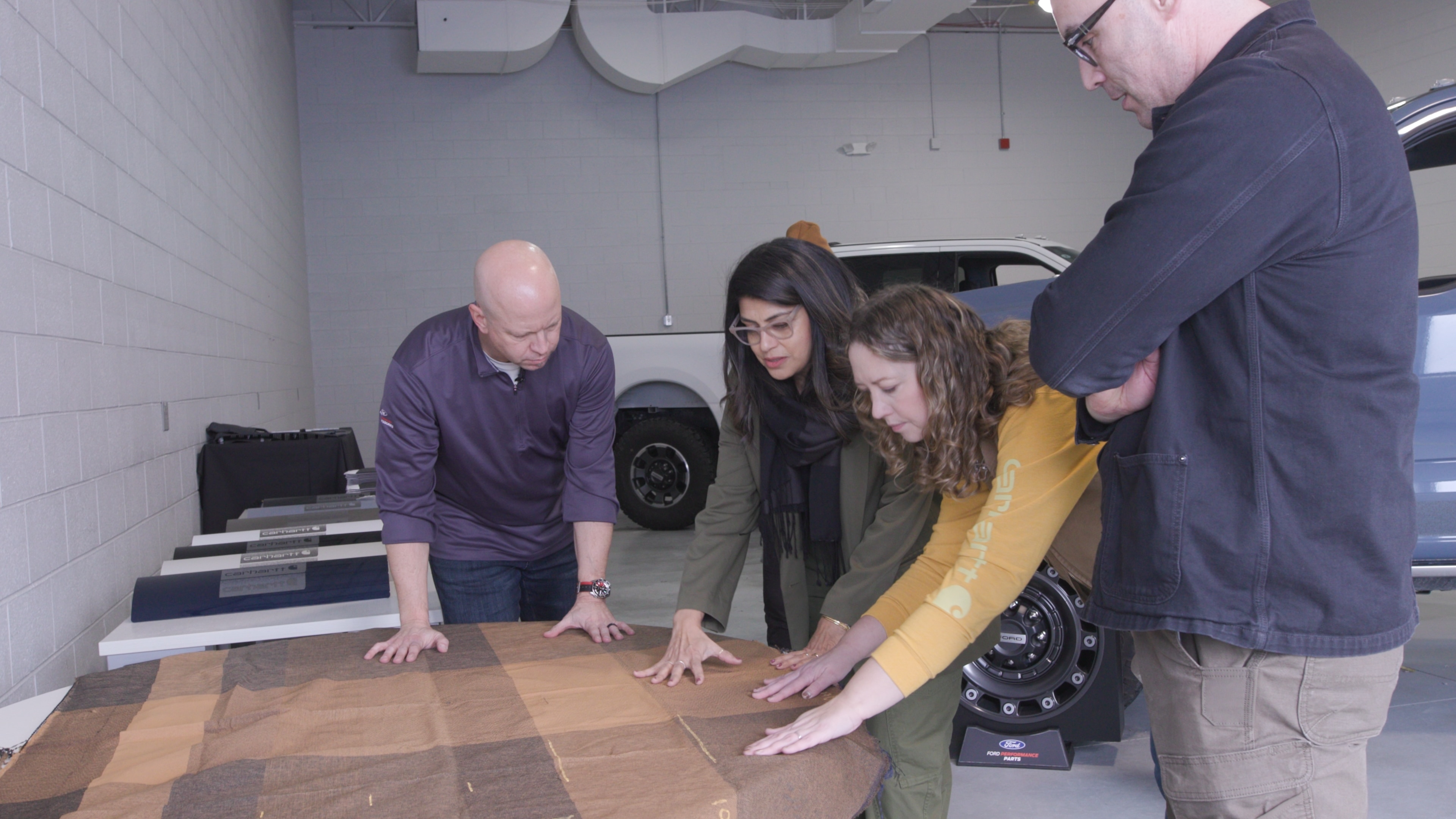 Steve Gilmore, Bhavna Mistry, Kristin Rodger, and Ben Ewy collaborating on the details of the 2027 Ford Super Duty Carhartt package design.