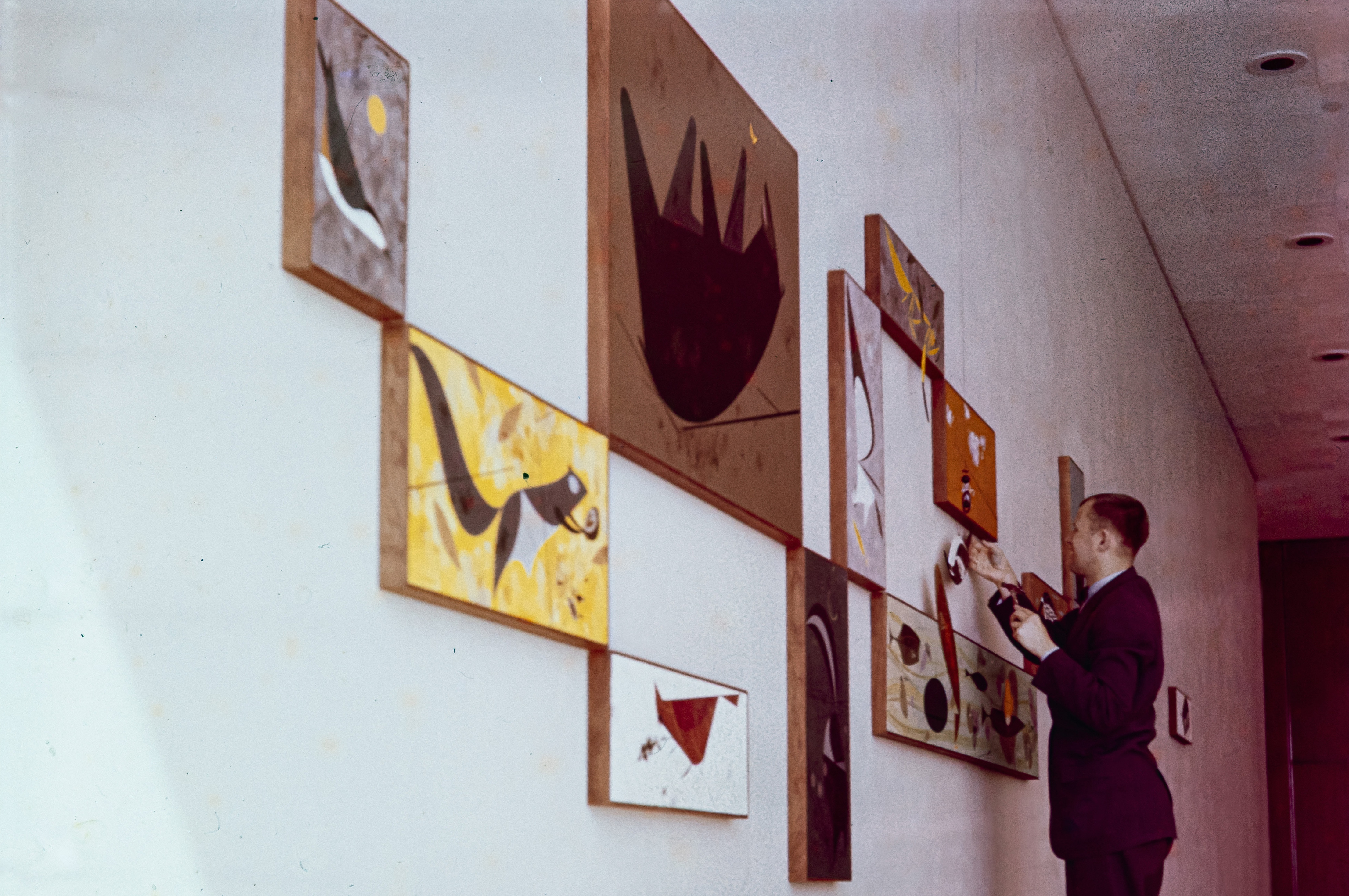 Charley installing his art at the Ford Motor Company in the 1950s. Credit: Edie Harper